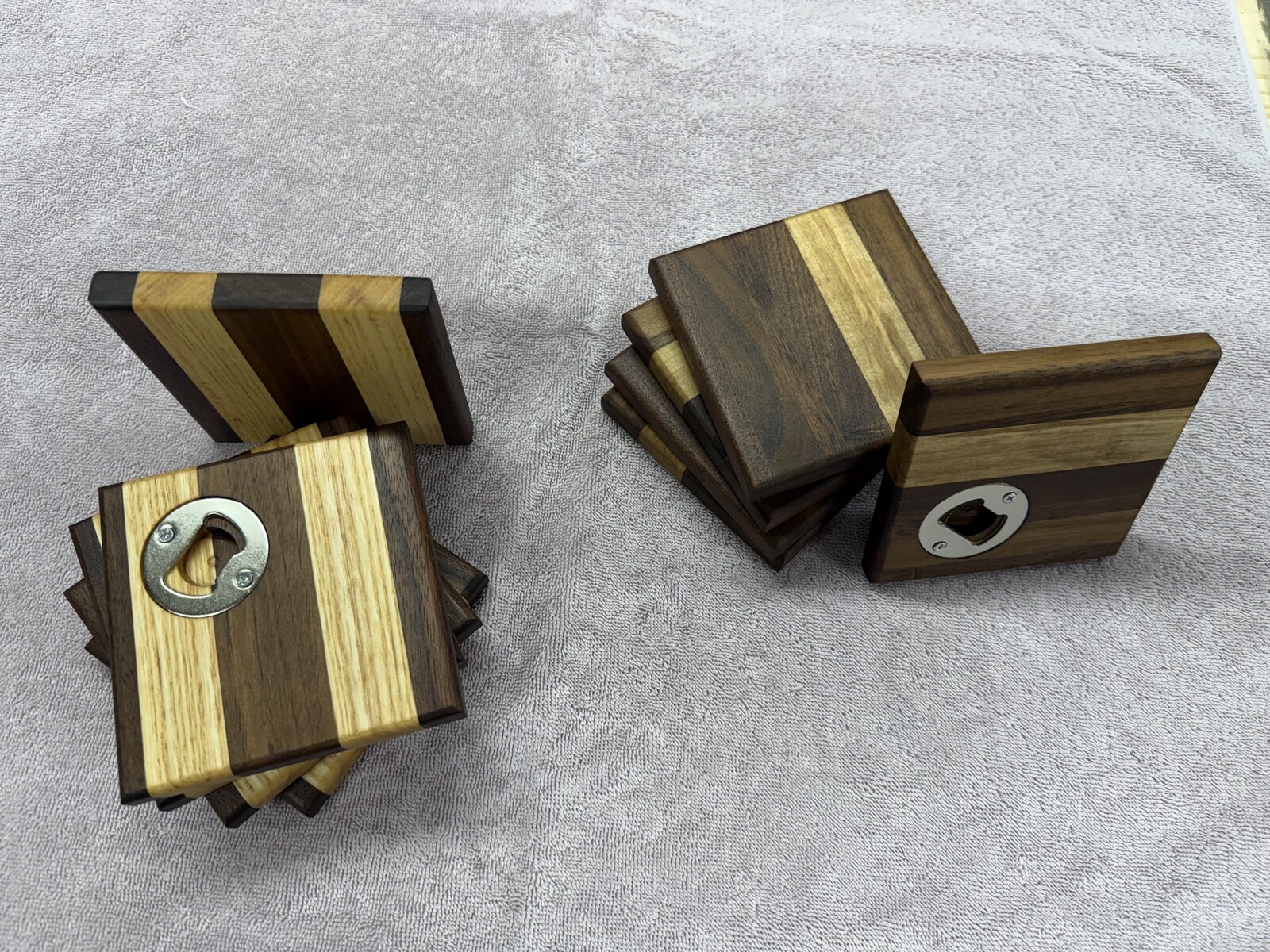 Two sets of hardwood coasters with built-in bottle openers