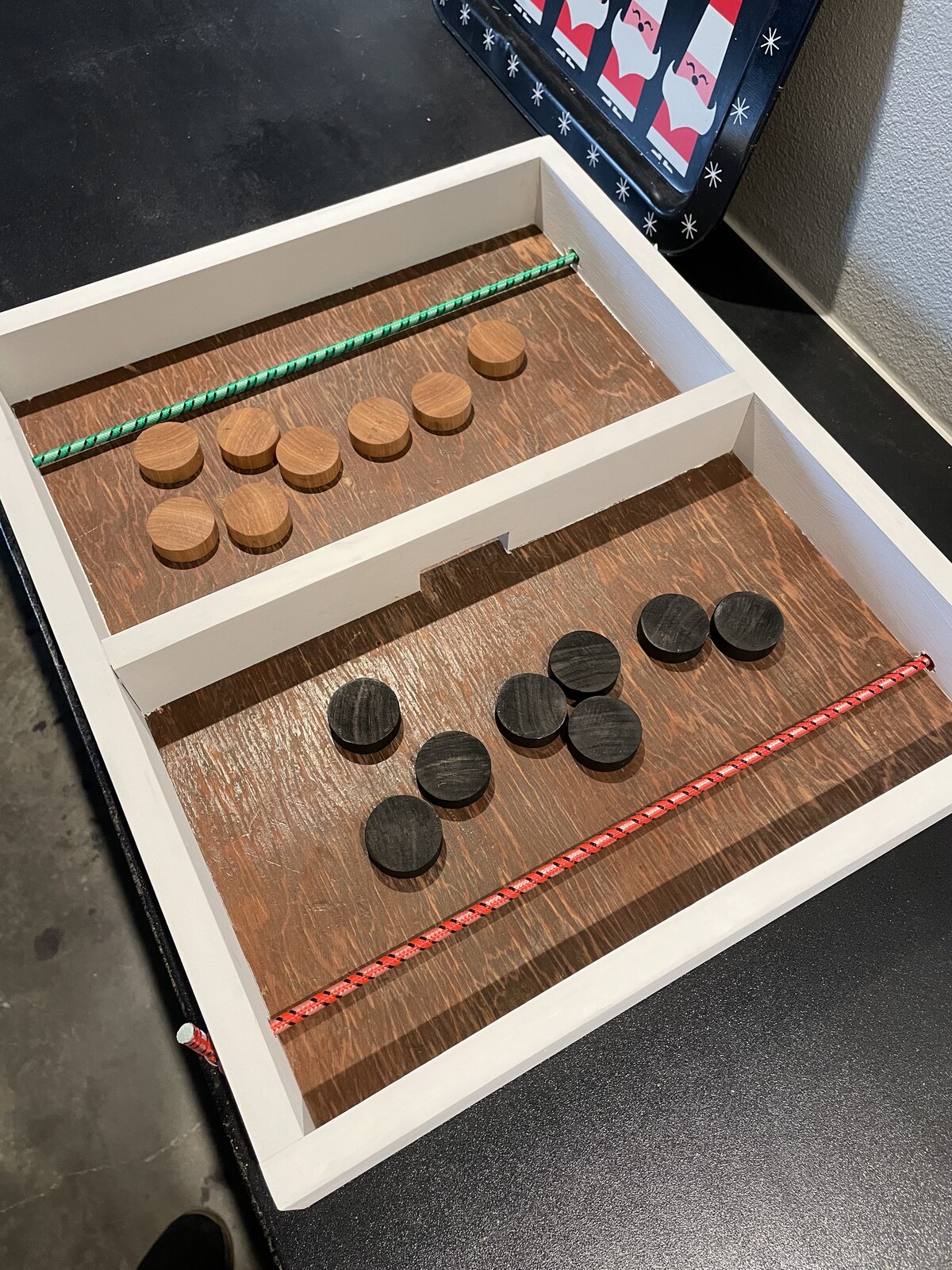 Handmade sling puck fast-track game with wooden pucks